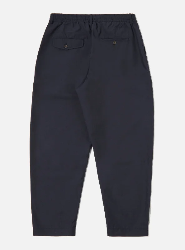 universal-works-pleated-track-pant-in-navy-tropical-suiting